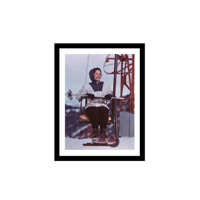 Hovedbilde woman takes ski chair lift ...